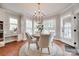Charming breakfast nook featuring a chandelier, bay windows, and a round wooden table with chairs at 645 Brookhaven Dr, Fort Mill, SC 29708