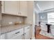 Convenient butler's pantry with granite countertops and ample cabinet space, ideal for serving and storage at 645 Brookhaven Dr, Fort Mill, SC 29708