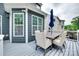 Deck features gray composite flooring, outdoor dining set with a blue umbrella at 645 Brookhaven Dr, Fort Mill, SC 29708