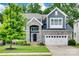Charming two-story home featuring stone accents, a manicured lawn, and a two-car garage at 645 Brookhaven Dr, Fort Mill, SC 29708