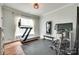 Home gym with a treadmill, weight rack, a mounted television and curtains on the window at 645 Brookhaven Dr, Fort Mill, SC 29708