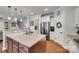 Kitchen with granite island, stainless steel appliances, and hardwood floors, adjacent to an eat-in area at 645 Brookhaven Dr, Fort Mill, SC 29708