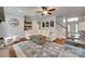 Bright living room with hardwood floors, a large sectional sofa, a decorative rug, and a staircase nearby at 645 Brookhaven Dr, Fort Mill, SC 29708