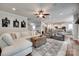 Open living room with hardwood floors, a sectional sofa, and views of the kitchen and breakfast nook at 645 Brookhaven Dr, Fort Mill, SC 29708