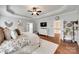 This main bedroom features hardwood floors, bright walls, and two entryways to attached rooms at 645 Brookhaven Dr, Fort Mill, SC 29708