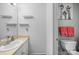 Clean bathroom with a sink, vanity, shelves, and a toilet with decorative wall art at 740 Tavern Ct # 7, Rock Hill, SC 29732