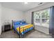Comfortable bedroom with a large window and a cozy bed with blue and yellow bedding at 740 Tavern Ct # 7, Rock Hill, SC 29732