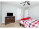 Cozy bedroom featuring a ceiling fan, and a patterned comforter, creating a comfortable retreat at 7414 Meridale Forest Dr, Charlotte, NC 28269