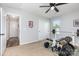 Bright bedroom with a ceiling fan, home gym, and view to the hallway at 7414 Meridale Forest Dr, Charlotte, NC 28269