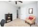 Comfortable bedroom with a bookshelf, chair, ceiling fan and access to the hallway at 7414 Meridale Forest Dr, Charlotte, NC 28269