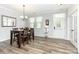 Elegant dining room featuring hardwood floors, modern lighting, and a stylish table setting at 7414 Meridale Forest Dr, Charlotte, NC 28269