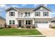 Charming two-story home with a balcony, well-manicured lawn, and stone accents at 7414 Meridale Forest Dr, Charlotte, NC 28269