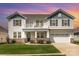 Charming two-story home with a balcony, well-manicured lawn, and stone accents at 7414 Meridale Forest Dr, Charlotte, NC 28269