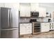Modern kitchen with stainless steel appliances, granite countertops, and beautiful white cabinets at 7414 Meridale Forest Dr, Charlotte, NC 28269