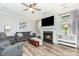 Cozy living room with a fireplace, comfortable seating, and hardwood floors at 7414 Meridale Forest Dr, Charlotte, NC 28269