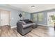 Inviting living room with wood floors, gray walls, comfortable gray seating, and a view of the backyard at 7414 Meridale Forest Dr, Charlotte, NC 28269