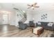 Bright living room with hardwood floors, neutral paint, and ample seating at 7414 Meridale Forest Dr, Charlotte, NC 28269