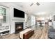 Open-concept living room with a fireplace, seamless flow to the dining, and hardwood floors at 7414 Meridale Forest Dr, Charlotte, NC 28269