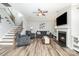 Comfortable living room with a fireplace, hardwood floors, and plenty of seating at 7414 Meridale Forest Dr, Charlotte, NC 28269