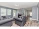 Living room featuring wood floors, gray walls, and a comfortable seating arrangement with access to the backyard at 7414 Meridale Forest Dr, Charlotte, NC 28269