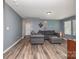Cozy living room with hardwood floors, gray walls, and comfortable gray furniture, creating a relaxing atmosphere at 7414 Meridale Forest Dr, Charlotte, NC 28269