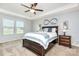 Spacious main bedroom with tray ceiling, ceiling fan, and natural light from the windows at 7414 Meridale Forest Dr, Charlotte, NC 28269