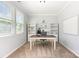 Well-lit home office with built-in shelving, a large desk, and ample natural light at 7414 Meridale Forest Dr, Charlotte, NC 28269