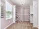Large walk-in closet with custom shelving and ample storage space at 7414 Meridale Forest Dr, Charlotte, NC 28269