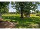Large backyard featuring a playground, mature trees, and room for outdoor activities at 7660 Bud Davis Rd, Vale, NC 28168