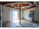 Unfinished basement with concrete floors, exposed ductwork, and a sliding glass door at 7660 Bud Davis Rd, Vale, NC 28168