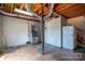 Unfinished basement with utilities, concrete flooring, and exposed wooden beams at 7660 Bud Davis Rd, Vale, NC 28168