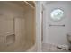 Bathroom with a shower-tub combination and an octagon window allowing natural light at 7660 Bud Davis Rd, Vale, NC 28168
