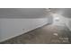 Spacious bonus room with neutral carpeting, white walls, and an air conditioner unit at 7660 Bud Davis Rd, Vale, NC 28168