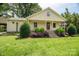 Charming home featuring a cozy porch, stone stairs, and meticulously manicured landscaping at 7660 Bud Davis Rd, Vale, NC 28168