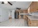 Bright eat-in kitchen boasts tile floors, wood cabinets and stainless steel appliances at 7660 Bud Davis Rd, Vale, NC 28168
