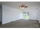 Bright living room with carpeted floor and sliding doors leading to backyard at 7660 Bud Davis Rd, Vale, NC 28168