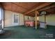 Covered patio with a hot tub, outdoor kitchen area, and artificial grass at 7660 Bud Davis Rd, Vale, NC 28168