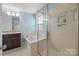 A pristine bathroom featuring a separate shower and tub, complemented by designer tile and a granite countertop at 809 Ayrshire Ave, Fort Mill, SC 29708