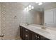 Bathroom vanity with double sinks, dark cabinets, wallpaper and a large mirror at 809 Ayrshire Ave, Fort Mill, SC 29708