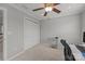 Bedroom features neutral walls, ceiling fan, carpet flooring, and a double door closet at 809 Ayrshire Ave, Fort Mill, SC 29708