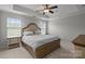 Primary bedroom with a tray ceiling, fan and carpeted floors features a king-size bed at 809 Ayrshire Ave, Fort Mill, SC 29708
