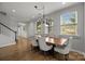 Elegant dining room with hardwood floors, large windows, and modern chandelier at 809 Ayrshire Ave, Fort Mill, SC 29708