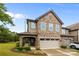 Beautiful two-story home features a stone and siding exterior with an attached two-car garage at 809 Ayrshire Ave, Fort Mill, SC 29708