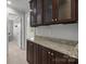Hallway with brown cabinets and granite countertops with gray walls and carpet flooring at 809 Ayrshire Ave, Fort Mill, SC 29708