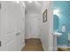 Hallway with half bath featuring a pedestal sink and wood flooring leading to the home's entrance at 809 Ayrshire Ave, Fort Mill, SC 29708