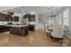 Open-concept kitchen with island, stainless steel appliances, and adjacent dining area at 809 Ayrshire Ave, Fort Mill, SC 29708
