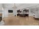 Spacious living room featuring hardwood floors, fireplace, entertainment center and a view to the kitchen at 809 Ayrshire Ave, Fort Mill, SC 29708