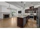Open living space with kitchen island, stainless appliances, and fireplace at 809 Ayrshire Ave, Fort Mill, SC 29708