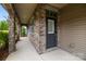 Inviting covered porch with stone accents and lush landscaping enhances curb appeal at 809 Ayrshire Ave, Fort Mill, SC 29708
