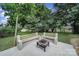 A backyard features two benches with a modern fire pit, perfect for outdoor gatherings at 842 Cherry S Rd, Rock Hill, SC 29732